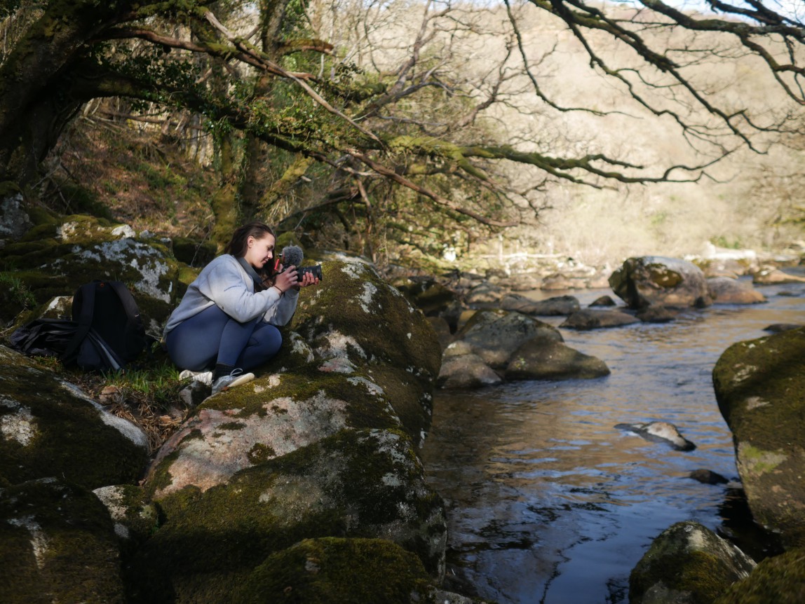 Olivia Chevallier of Whole Earth Film Productions filming on set at Dartmoor National Park, UK